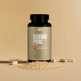 Ashwa Pure (KSM-66 Ashwagandha) Flasche mit Kapseln und Pulver vor beige Hintergrund, Galerieposition 1