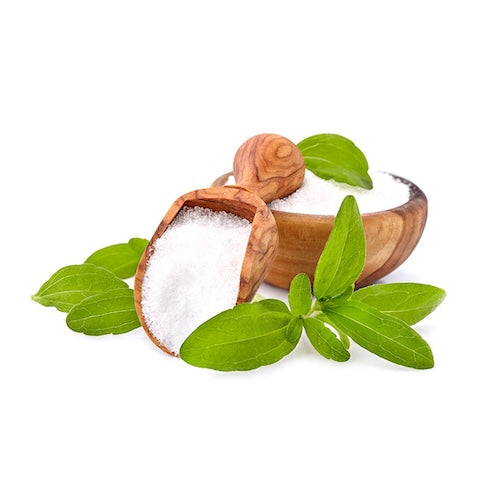 Wooden bowl and scoop filled with white powder alongside fresh green leaves on white background