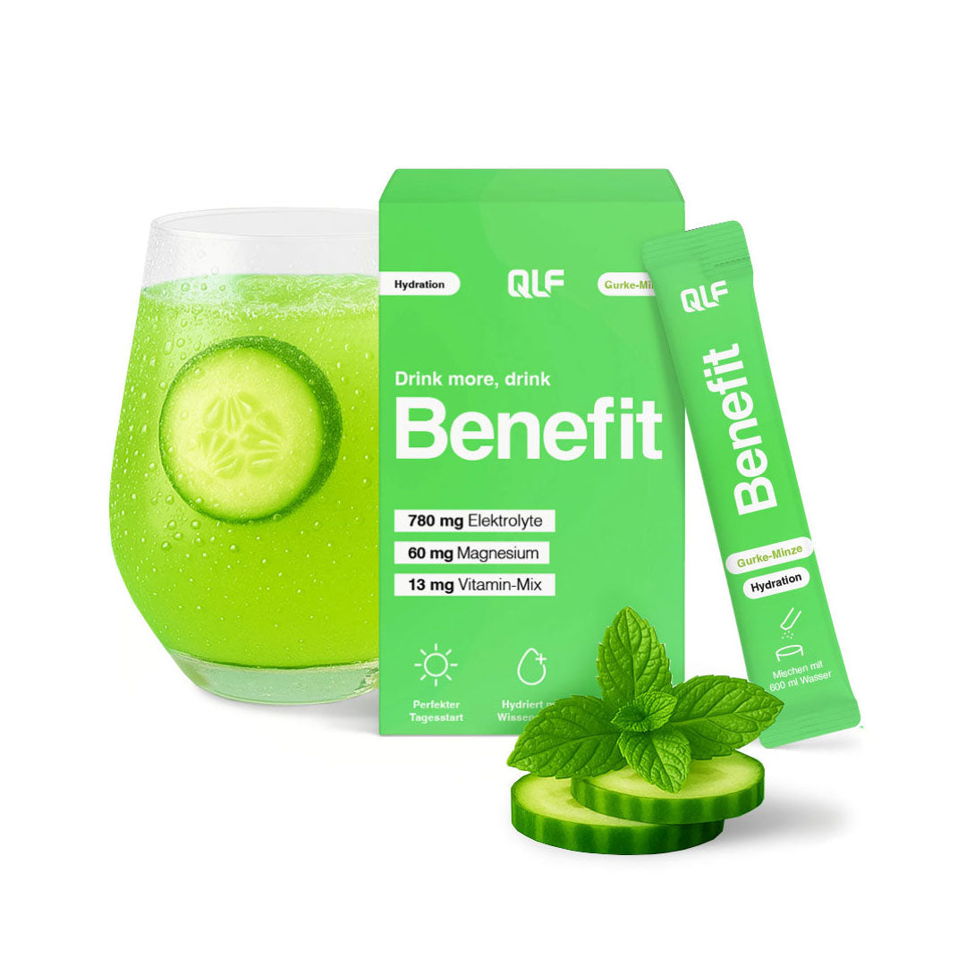 Green hydration sachet and box beside a glass with cucumber slices and fresh mint leaves on white background
