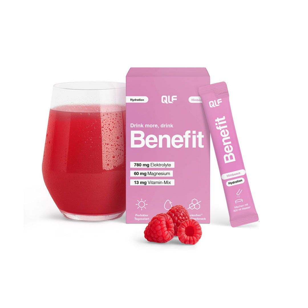 Glass of red hydration drink with pink Benefit sachet and box and fresh raspberries on white background