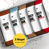 Tasty Bar Proteinriegel Probierbox mit fünf verschiedenen Sorten, elegant verpackt und übersichtlich präsentiert.